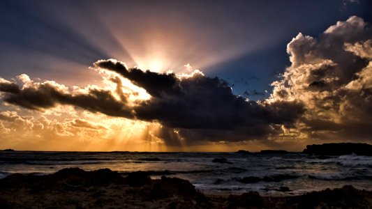 Body Of Water Under Clouds With Sun Rays photo