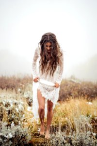Woman Wearing White Lace Long-sleeved Dress Walking On Grass