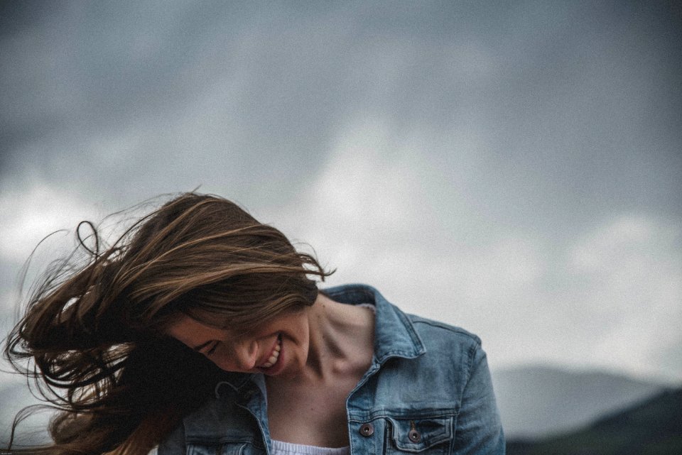 Woman Wears Blue Denim Top And White Inner Smiling photo