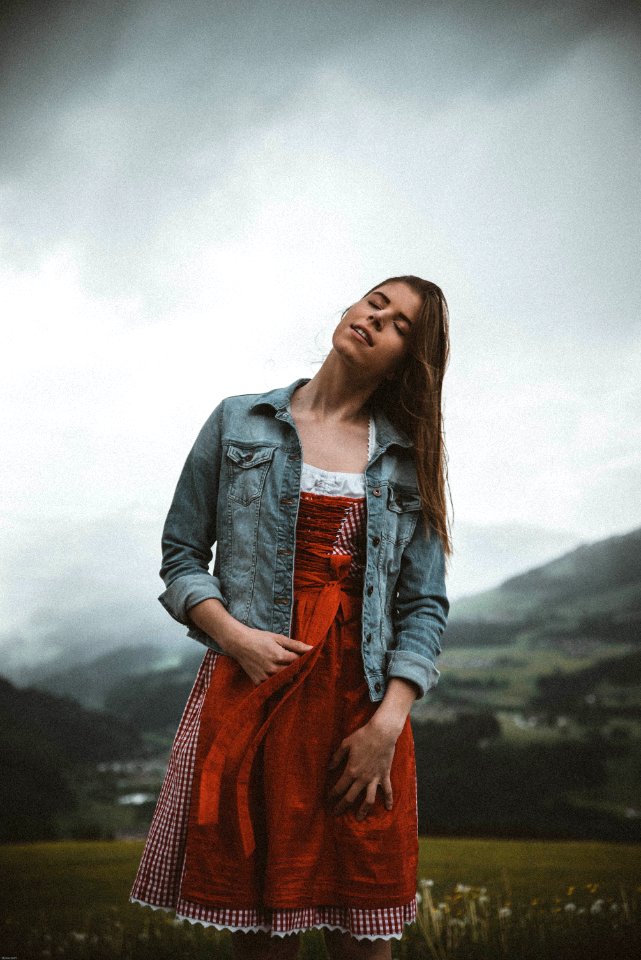 Woman In Red And White Dress Posing For Photo