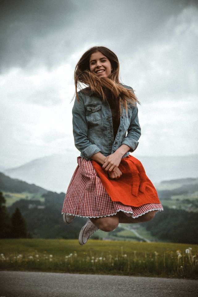 Woman In Blue Denim Jacket Jumping