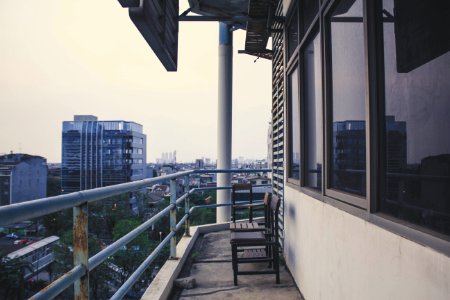 Two Wooden Chairs On Terrace Of Building