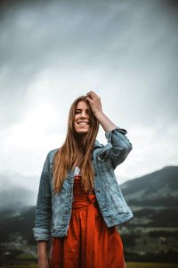 Woman Wearing Blue Denim Button-up Jacket Under Heavy Clouds