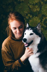 Woman Holding Adult Siberian Husky