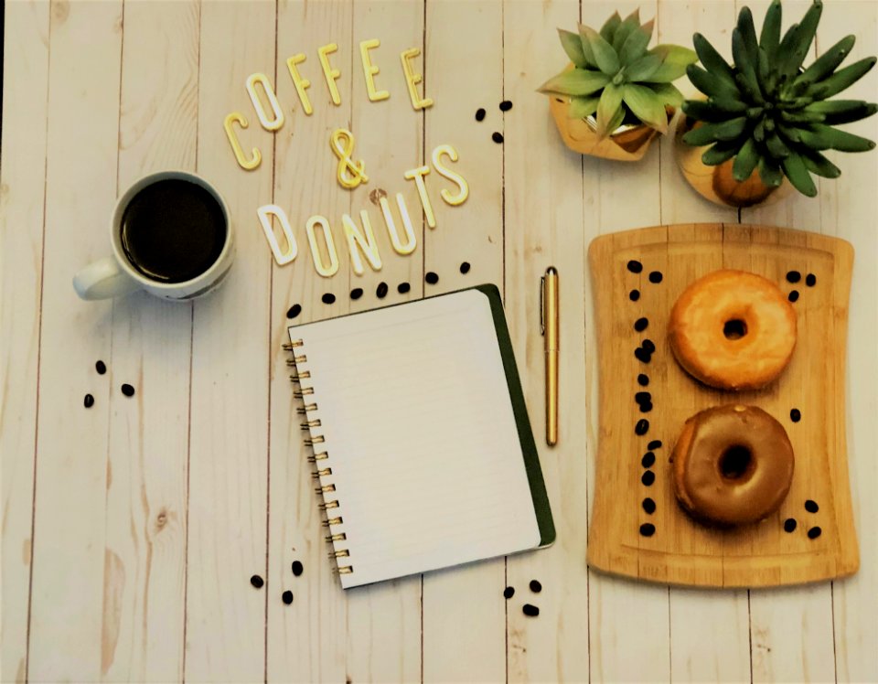 Spiral Notebook Beside Pen And Plants