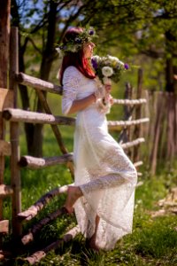 Woman In White Long-sleeved Gown Holding Flower Bouquet photo