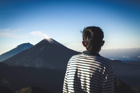 Man Wearing Striped Shirt Looking At Volcano photo