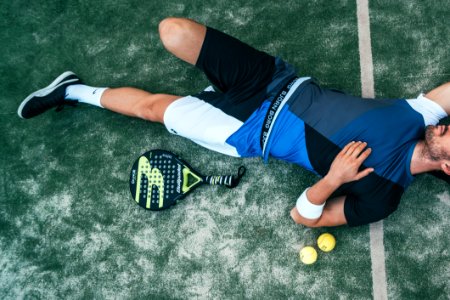 Man Lying Beside On Green Tennis Balls photo