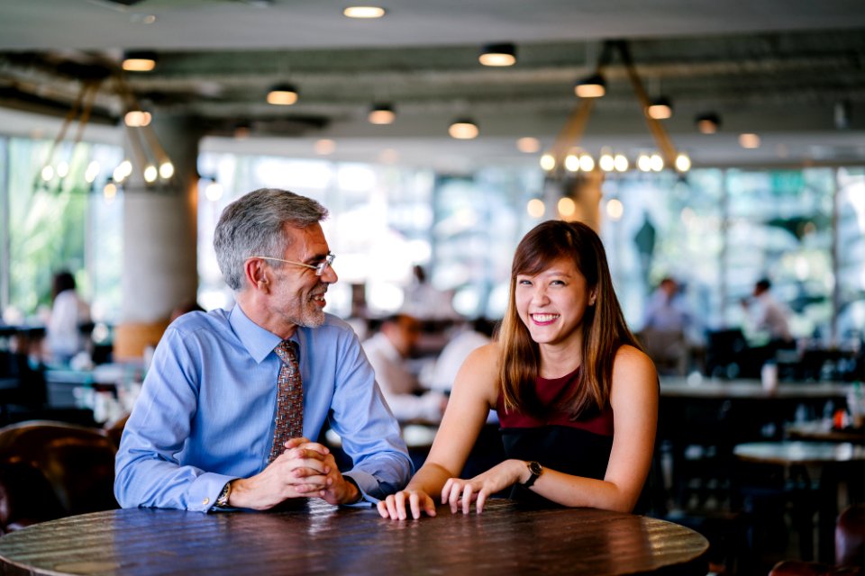 Photography Of Man And Woman Sitting Together