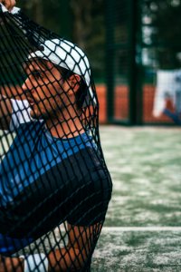 Person Sitting On Grass Holding Goal Net photo