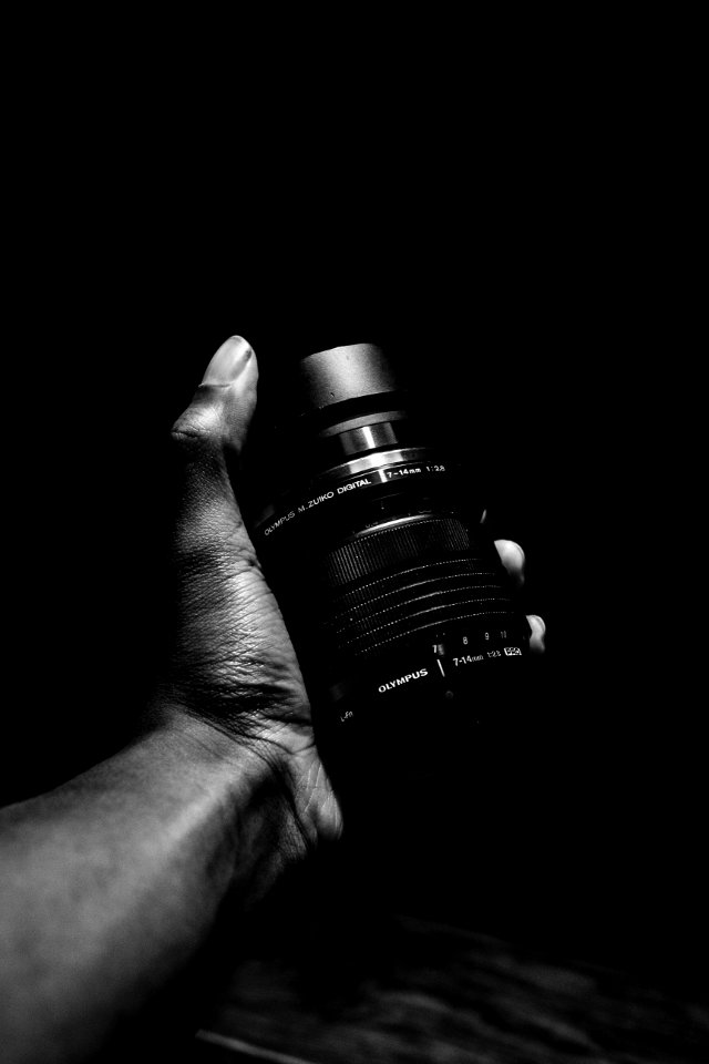Person Holding Olympus Camera Lens