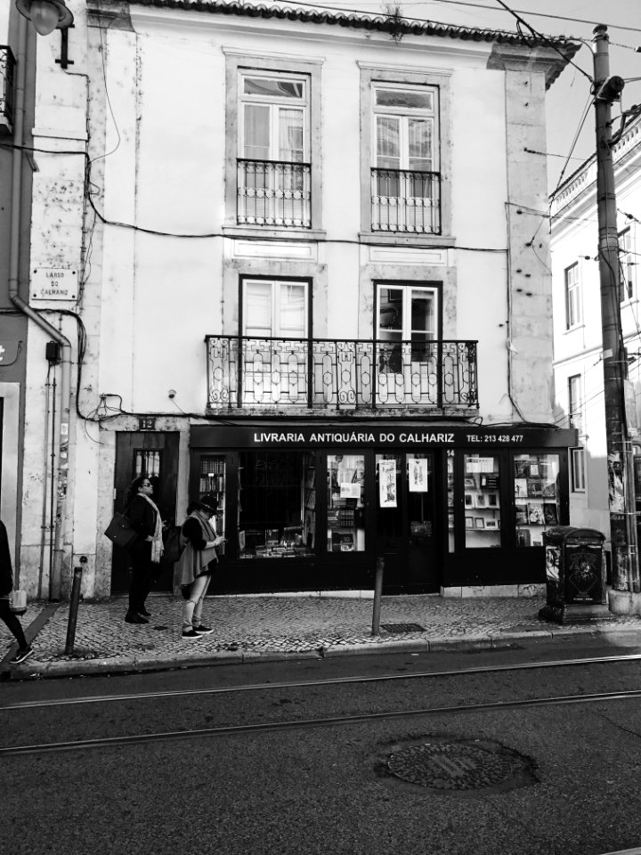 Grayscale Photography Of Women Standing Near Building photo