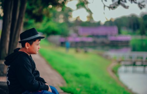 Boy Wearing Black Zip-up Hoodie And Black Fedora Hat photo