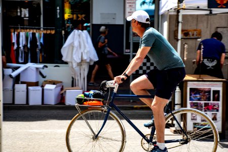 Man Wearing Grey T-shirt Riding Bicycle photo
