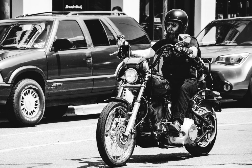 Greyscale Photo Of Man Riding Motorcycle