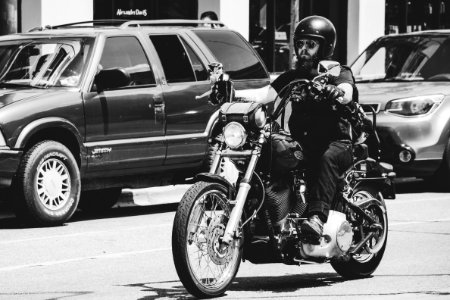 Greyscale Photo Of Man Riding Motorcycle photo