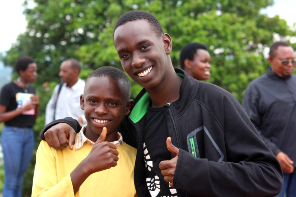 Two Boys Doing Thumbs Up Sign