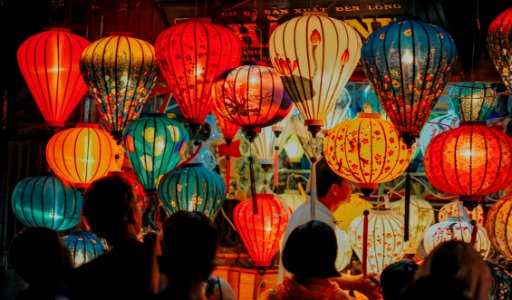 People Standing Near Assorted-color Lamps
