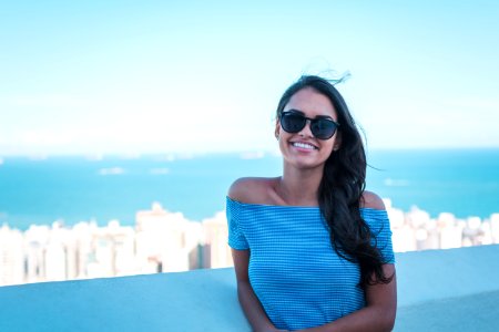 Woman Wearing Blue Off-shoulder Top Smiling photo