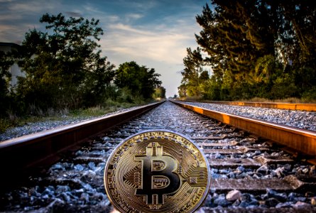 Gold-colored Bitcoin On Railroad