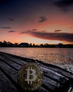 Body Of Water During Dawn With Bitcoin Logo Text Overlay