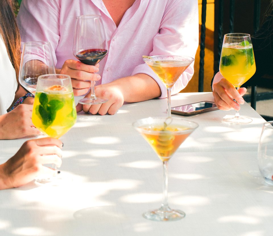 Clear Cocktail Glass On Top Of White Wooden Table