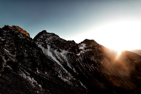 Gray Rock Mountain With White Snow During Sun Rise Aerial Photography photo