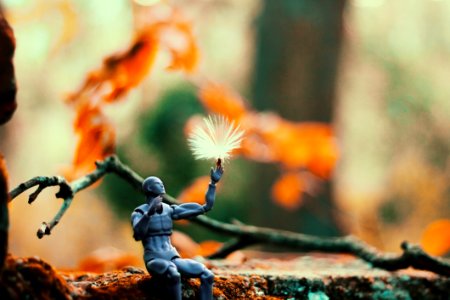 Sitting Gray Action Figure Beside Brown Tree Branch