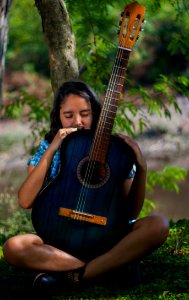 Woman Holding Blue Classical Guitar