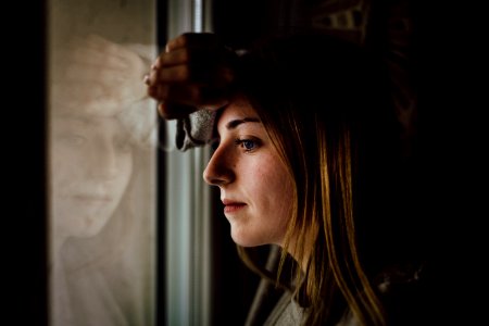 Woman Leaning On Glass Window photo