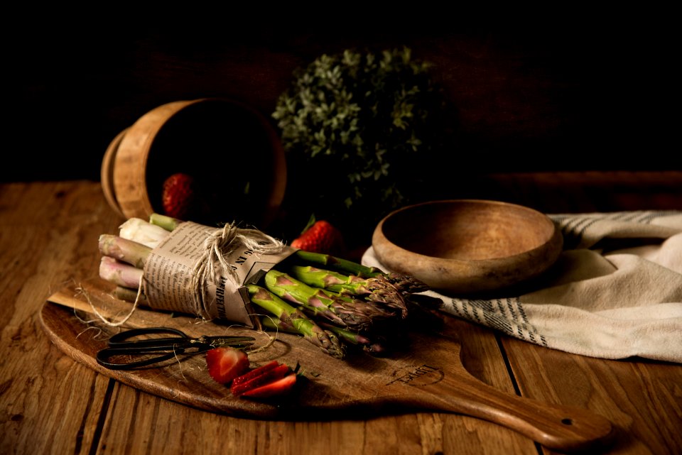 Asparagus On Wooden Board Beside Wooden Bowl