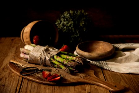Asparagus On Wooden Board Beside Wooden Bowl