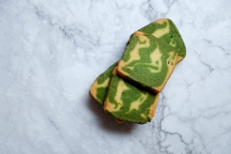 Green And Brown Pastries On White Surface