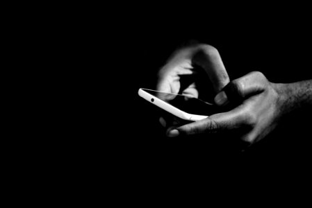 Grey Scale Photo Of Person Holding Smartphone photo