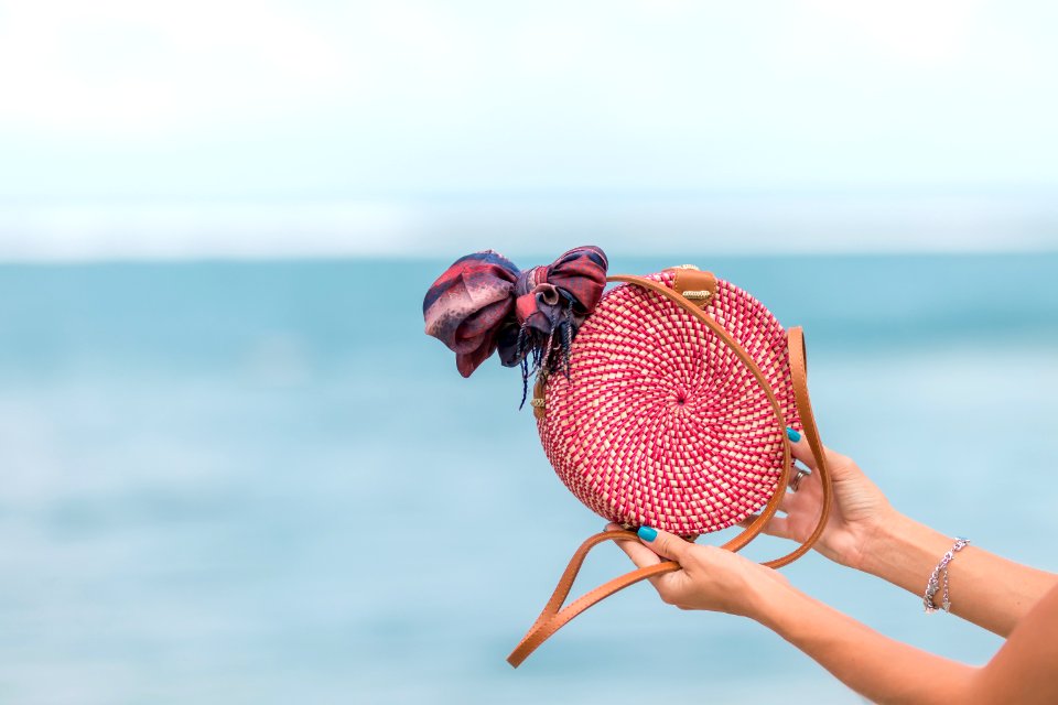 Selective Focus Photography Of Person Holding Red And Brown Leather Crossbody Bag
