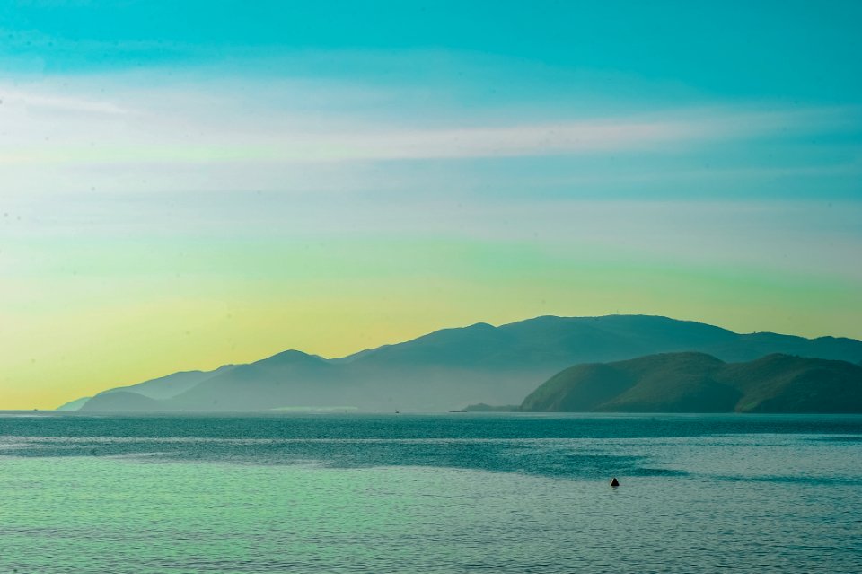 Body Of Water Overlooking Islands Under Blue Daytime Sky