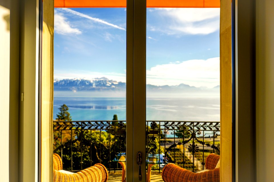 Brown Chairs Near Black Railings