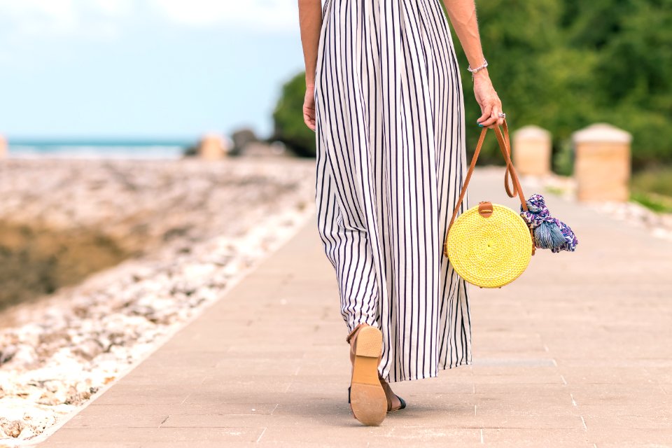 Woman Wearing Black And White Striped Maxi Skirt Holding Brown Bag