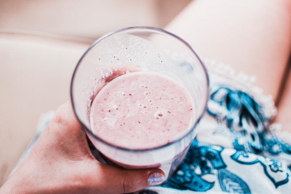 Person Holding Clear Drinking Glass With Fruit Shake Close-up Photo
