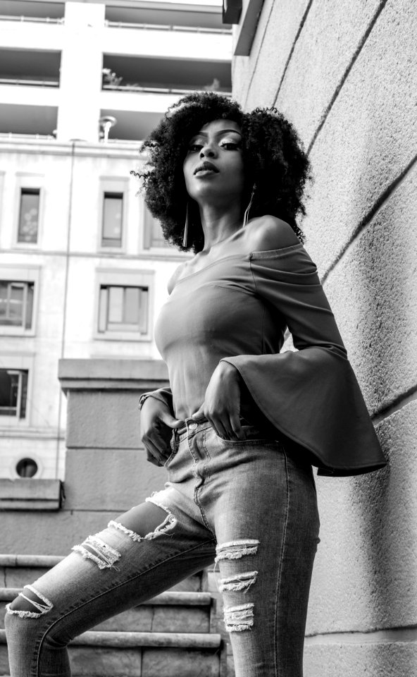 Grayscale Photo Of Woman Posing Beside The Wall photo