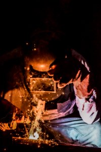 Photography Of A Person Wearing Welding Mask