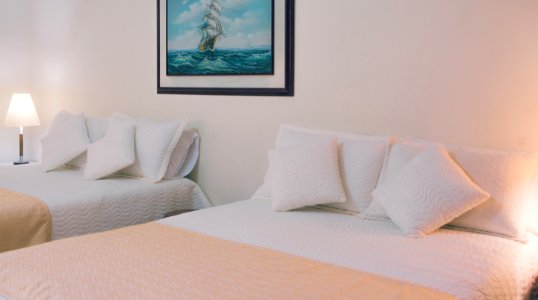 Two White Bed Mattresses Near Wall photo