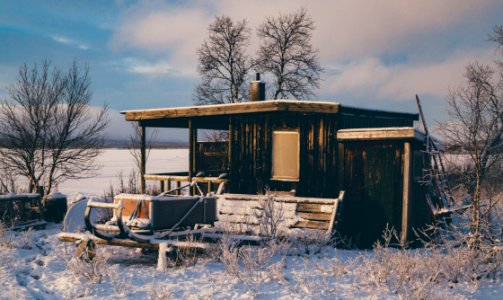 Brown Wooden Barn Surrounded By Snow photo