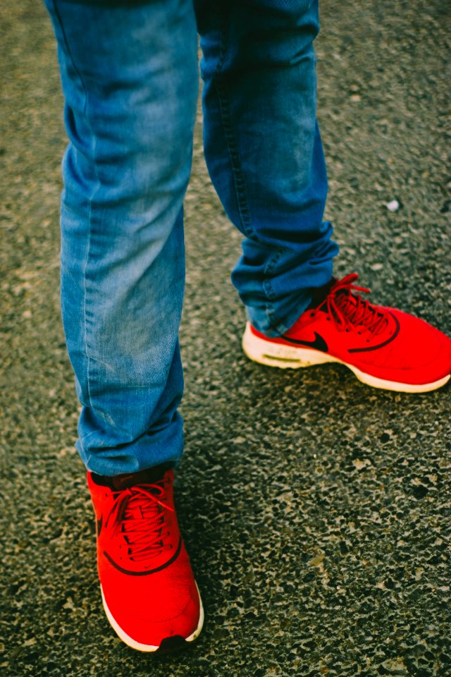 Person Wearing Red Nike Running Shoes