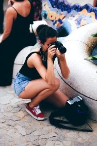 Woman In Black Tank Top Holding Dslr Camera photo