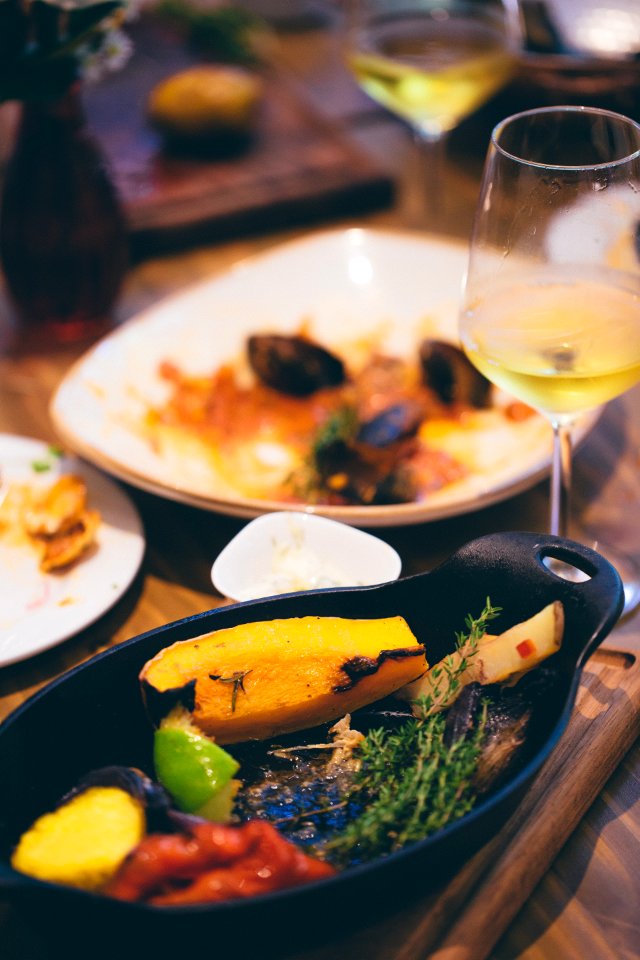 Sizzling Plate Filled By Sliced Fruit And Herb