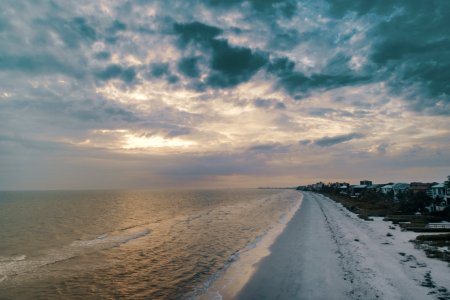 Wide Angle Photo Of Shore Under Cloudy Sky photo