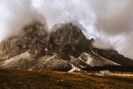 Gray House Under Gray And White Volcanos Foot