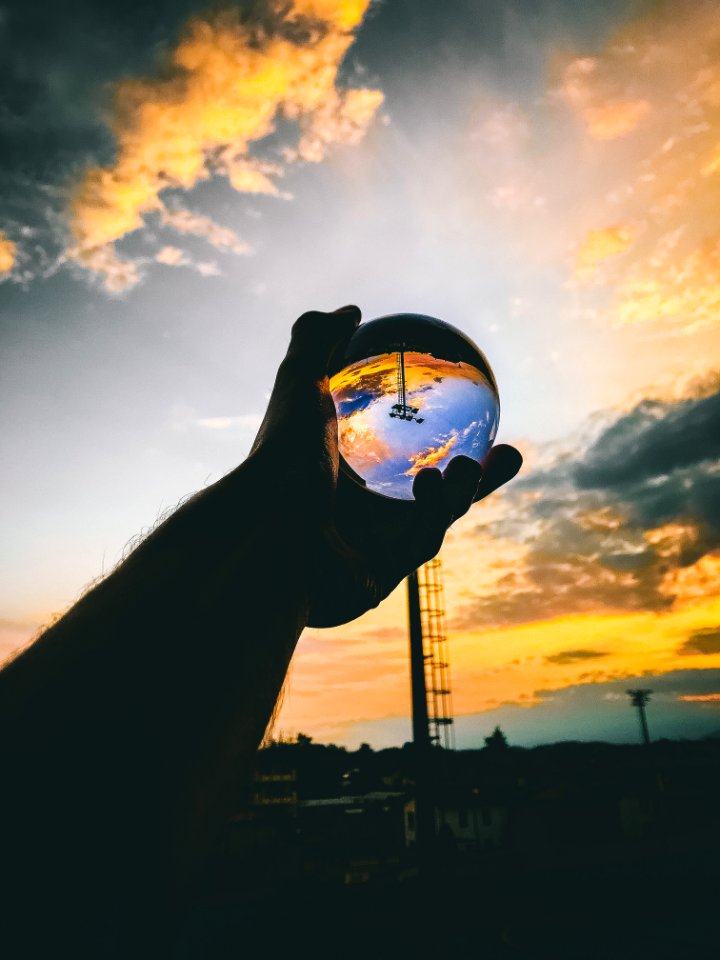 Person Holding Glass Ball