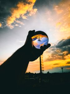 Person Holding Glass Ball